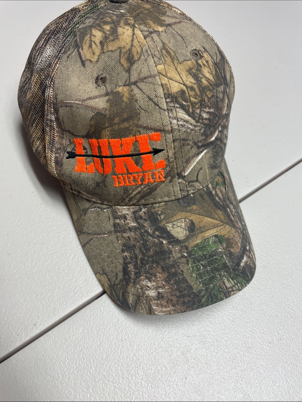 Realtree Camo Baseball Cap with Orange Logo with Luke Bryan Logo